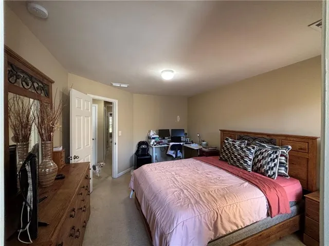 a bedroom with a bed and a lamp