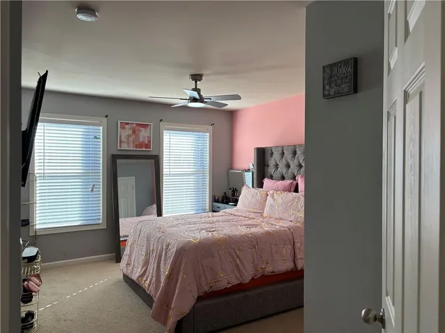a bedroom with a bed and a mirror