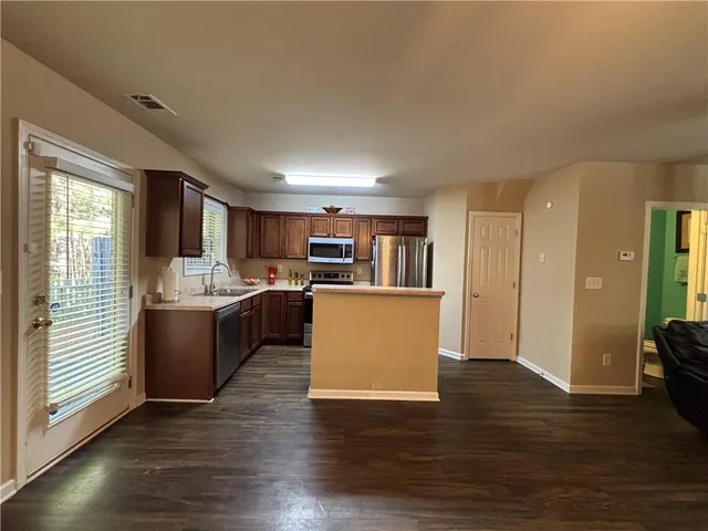 a view of kitchen with wooden floor