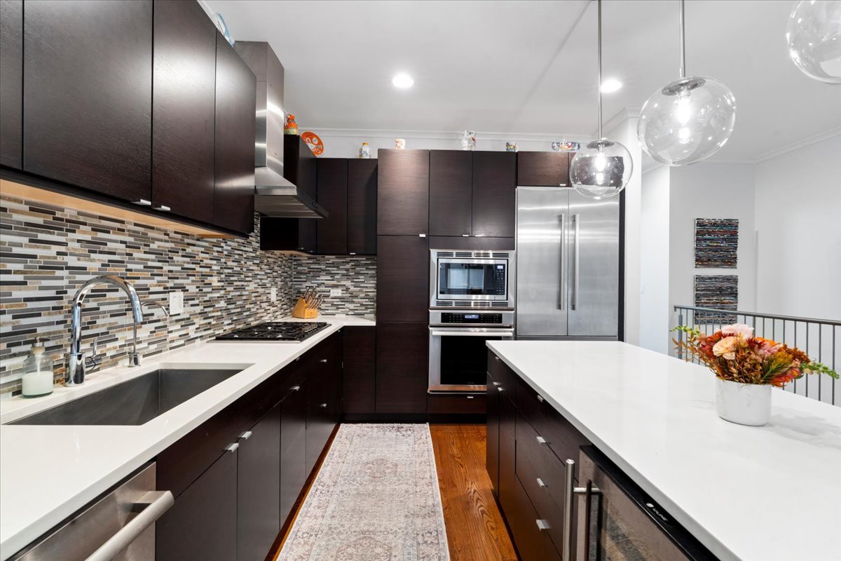 1515 North Mohawk Street, Unit 1 Chicago, IL 60610 - Photo 11 of 34 a kitchen with stainless steel appliances kitchen island granite countertop a sink and stove