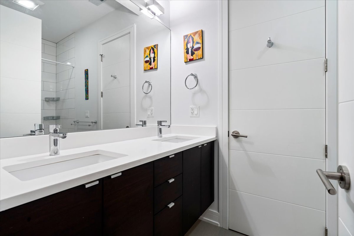 1515 North Mohawk Street, Unit 1 Chicago, IL 60610 - Photo 25 of 34 a bathroom with a double vanity sink and a mirror