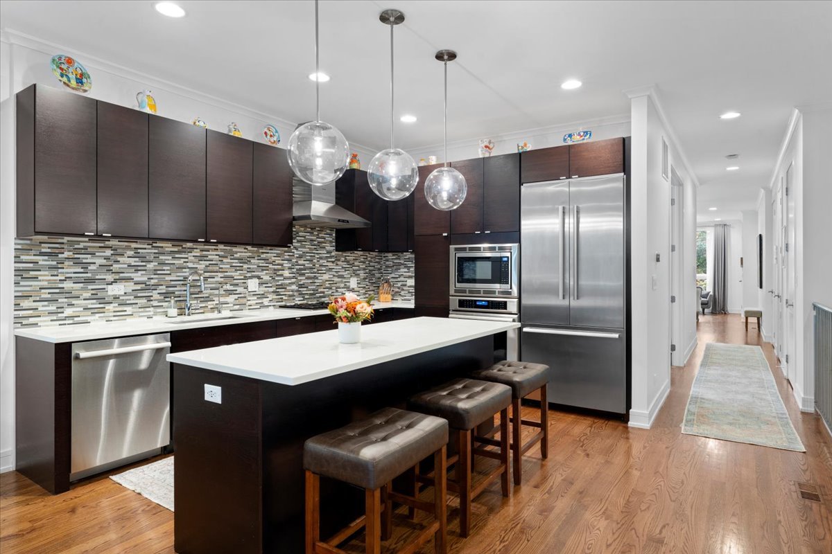 1515 North Mohawk Street, Unit 1 Chicago, IL 60610 - Photo 10 of 34 a kitchen with stainless steel appliances granite countertop a sink refrigerator and microwave