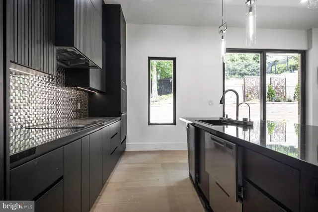 a kitchen with granite countertop a stove and a sink