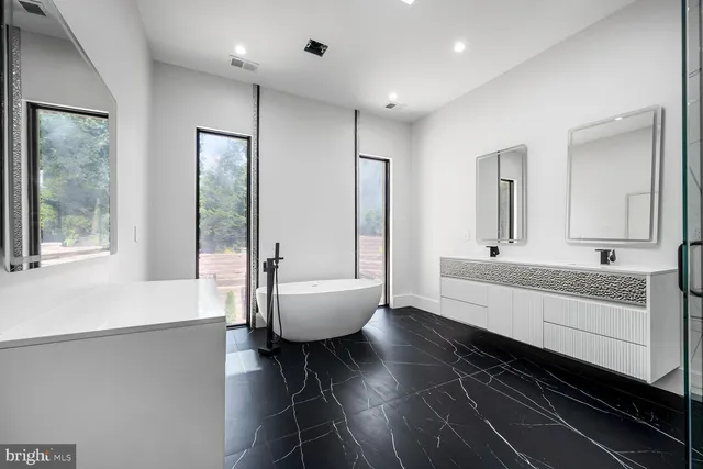 a large white kitchen with a large window