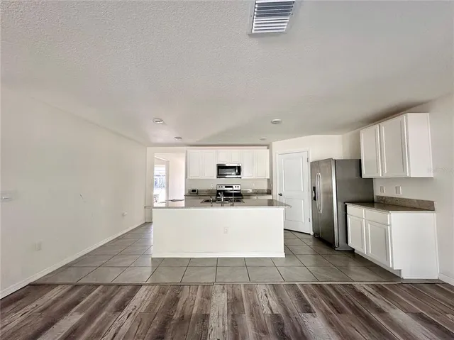 a kitchen with sink a stove and refrigerator