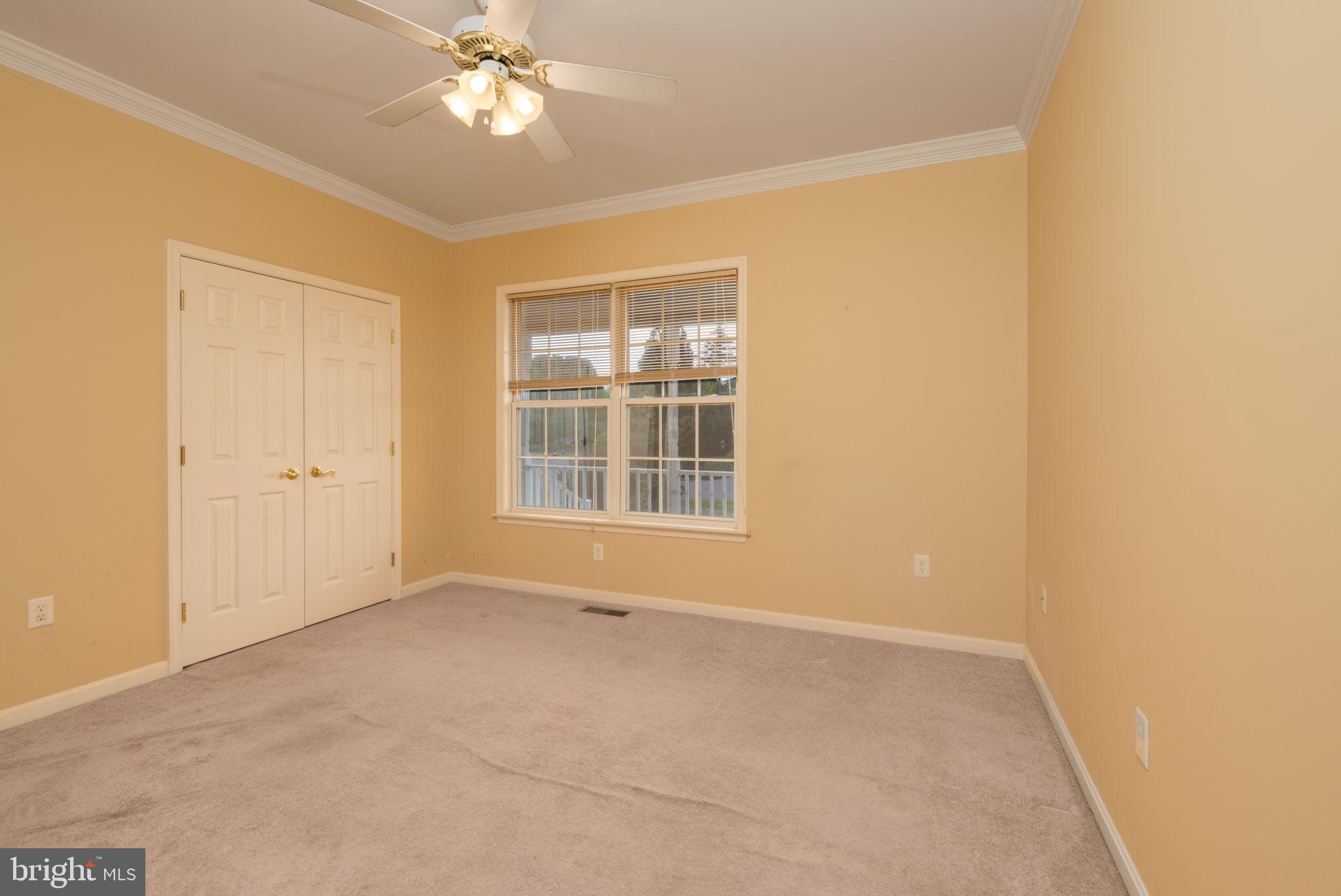 16841 Devon Road Lewes, DE 19958 - Photo 27 of 43 an empty room with a ceiling fan and a window