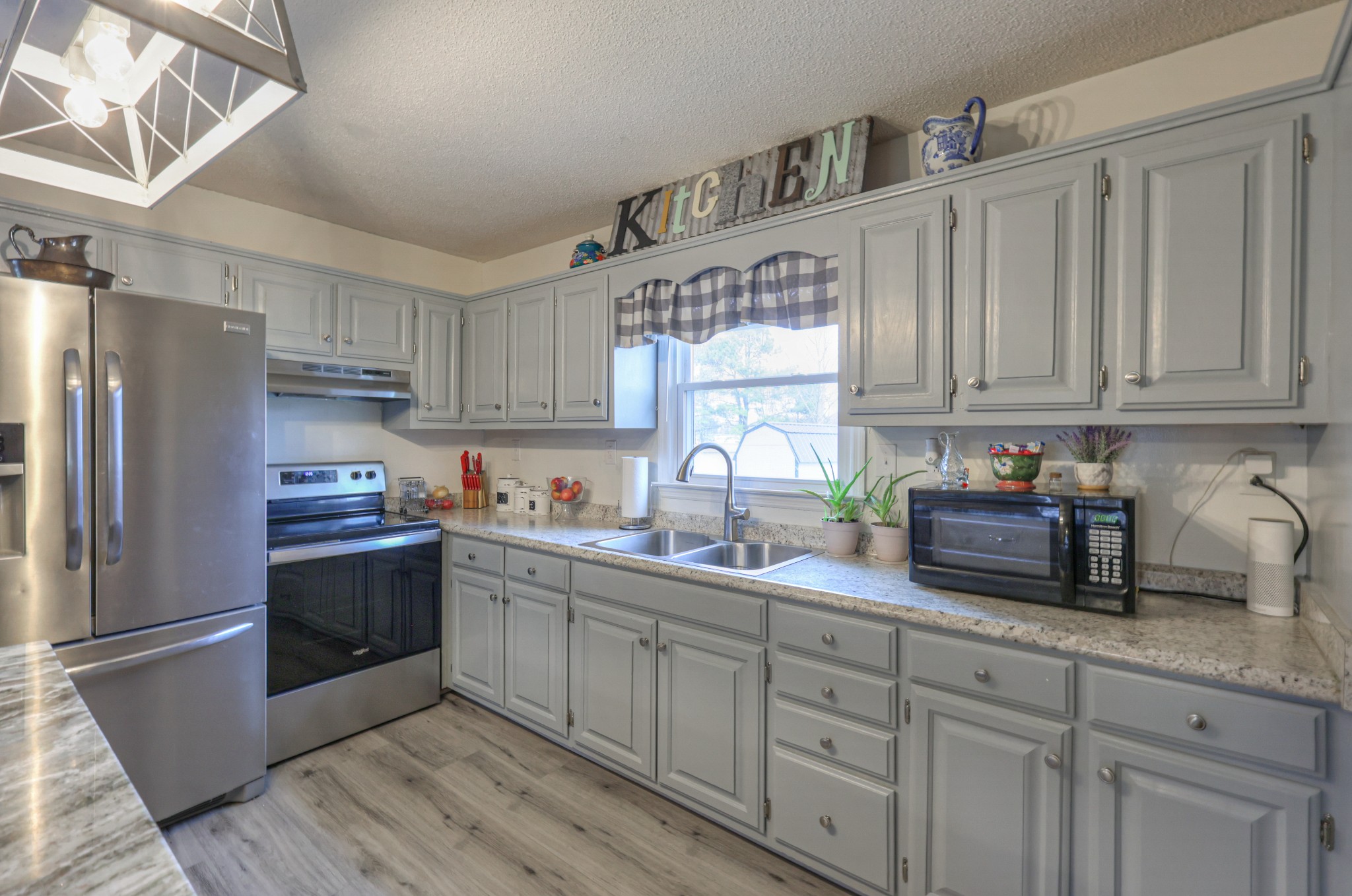 636 Warner Bridge Road Shelbyville, TN 37160 - Photo 11 of 32 a kitchen with stainless steel appliances granite countertop a refrigerator sink and cabinets