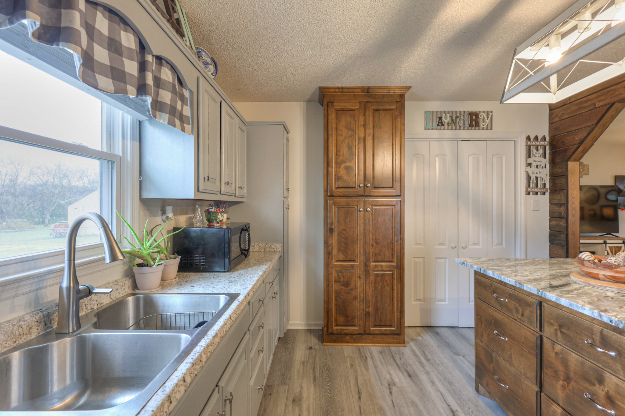636 Warner Bridge Road Shelbyville, TN 37160 - Photo 13 of 32 a kitchen with kitchen island granite countertop a sink stainless steel appliances and cabinets