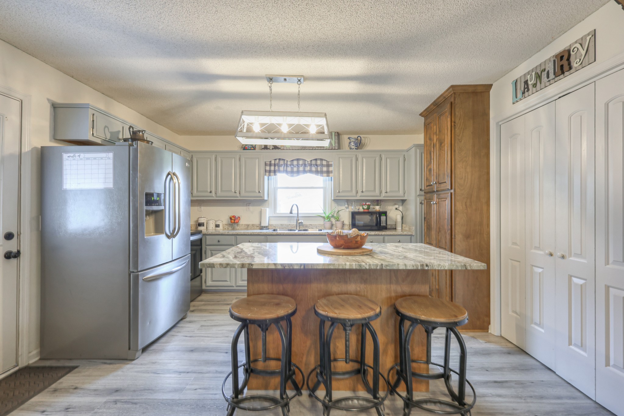 636 Warner Bridge Road Shelbyville, TN 37160 - Photo 10 of 32 a kitchen with stainless steel appliances granite countertop a dining table chairs refrigerator and cabinets