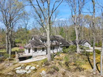 a view of a house with large trees