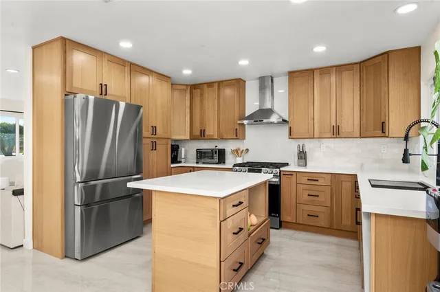 a kitchen with stainless steel appliances granite countertop a refrigerator stove a sink and a microwave