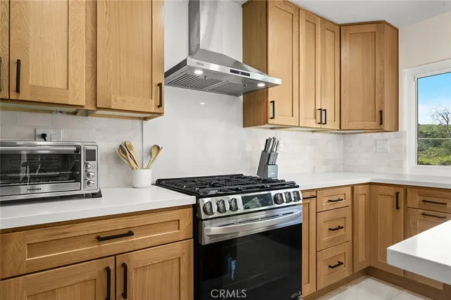 a stove top oven sitting inside of a kitchen