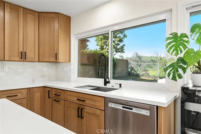a kitchen with a sink and large window