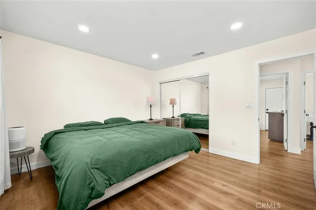 a room with a bed and a potted plant