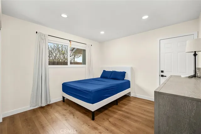 a living room with a bed and a dresser