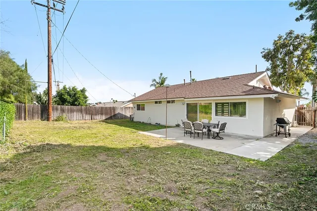 a view of a house with swimming pool and sitting area