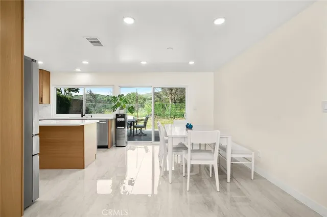 a view of a dining room with furniture window and outside view