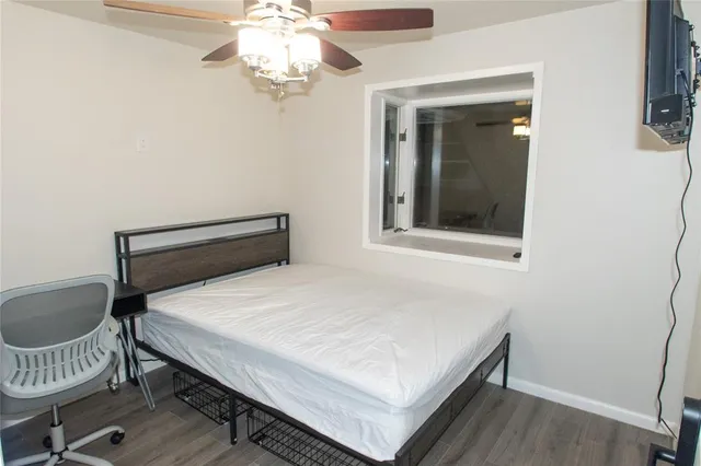 a bedroom with a bed and a window