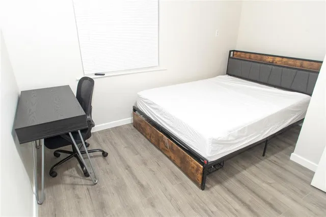 a bedroom with a bed and a desk