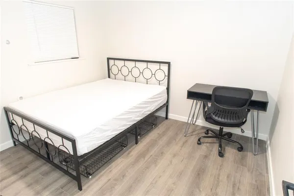 a bedroom with a bed and chair