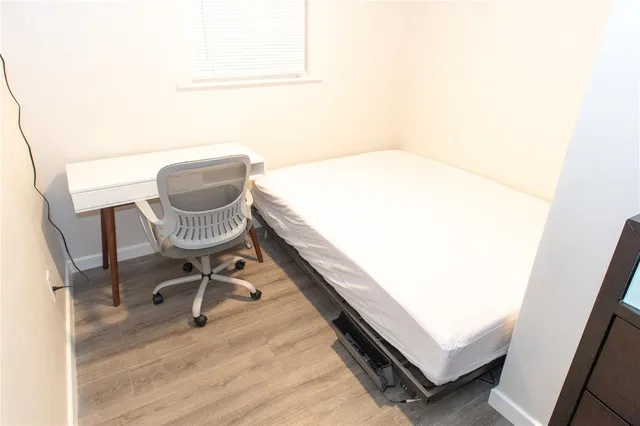 a room with a chair and wooden floor