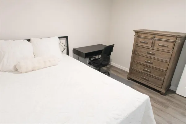 a bedroom with a bed and a dresser