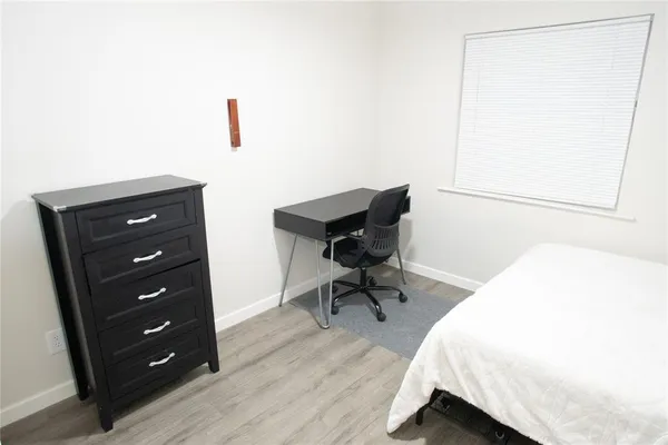 a bedroom with a bed and a dresser
