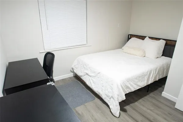 a bed sitting in a bedroom next to a window