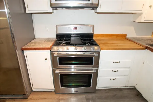 a stove top oven sitting inside of a kitchen