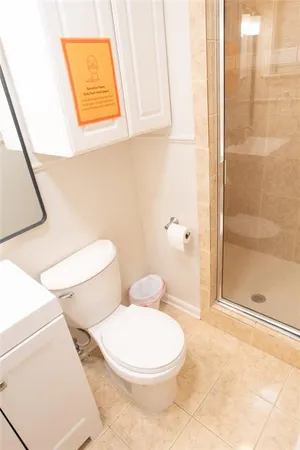 a white toilet sitting next to a bathroom sink