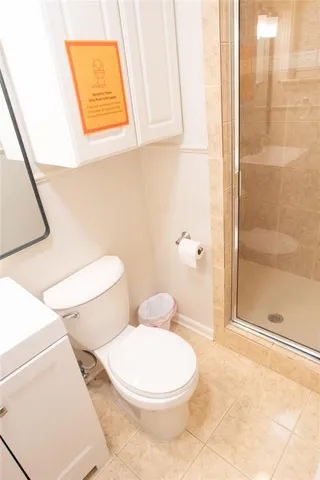a white toilet sitting next to a bathroom sink