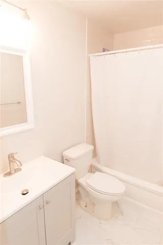 a white toilet sitting next to a bathroom sink