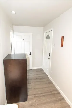 a view of a hallway to the house and wooden floor