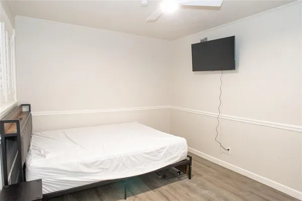 a bedroom with a bed and a flat screen tv