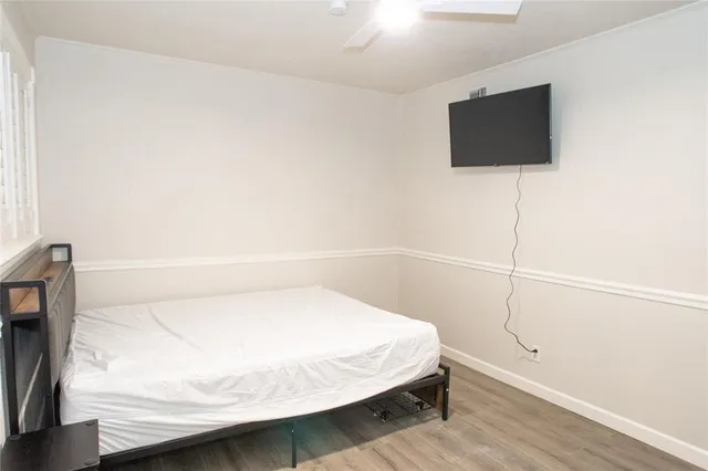 a bedroom with a bed and a flat screen tv