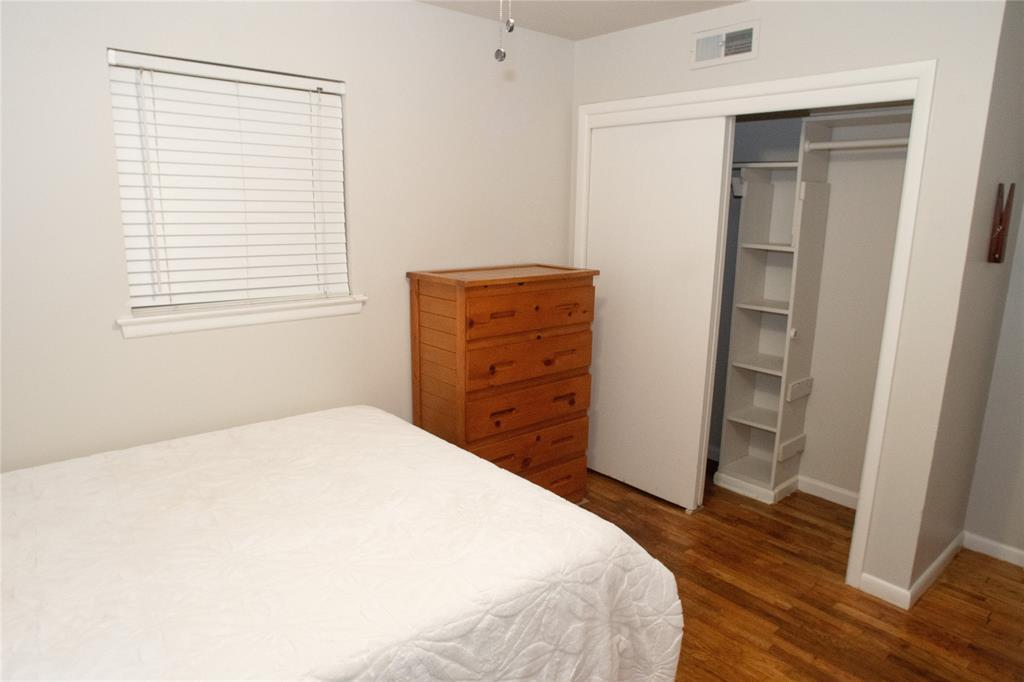 2129 Province Lane Dallas, TX 75228 - Photo 10 of 33 a bedroom with a bed and wooden floor