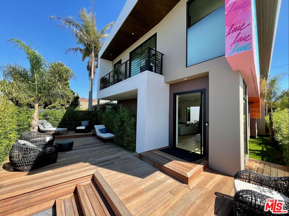 a view of balcony with furniture and potted plants