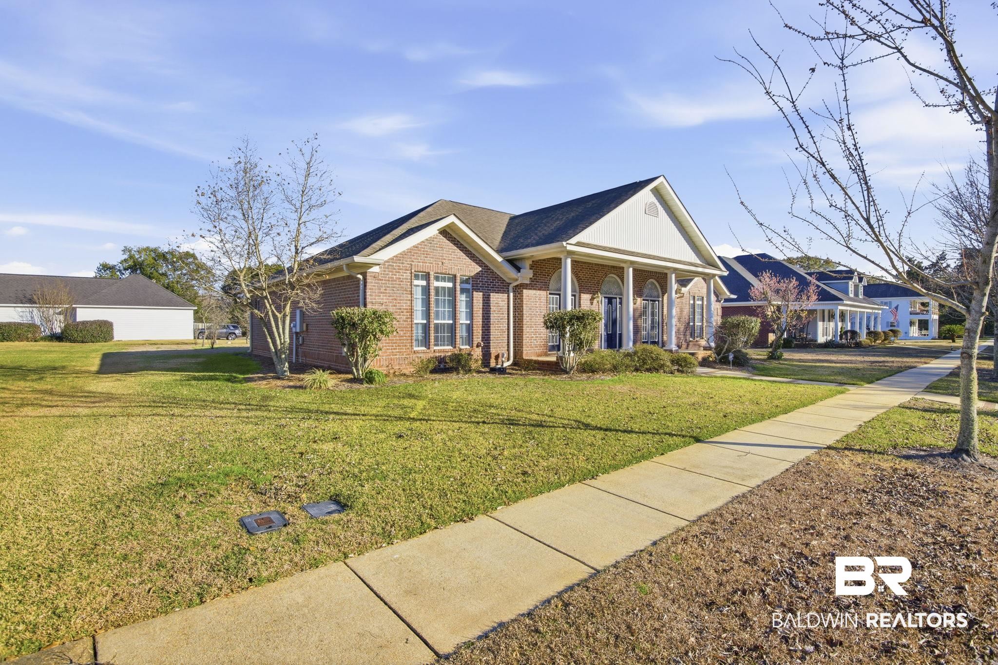 29634 St George Street Daphne, AL 36526 - Photo 5 of 47 Greek revival inspired property with covered porch, a front lawn, and brick siding