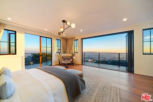a living room with furniture and a floor to ceiling window