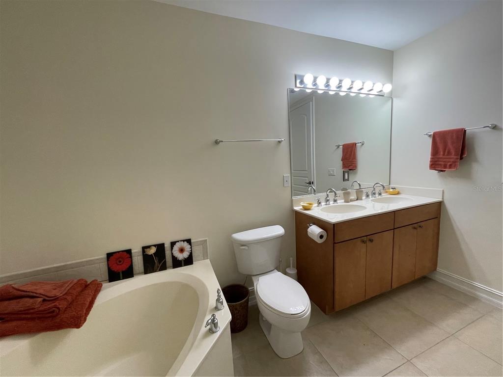 4400-4420 Bonita Beach Walk Drive, Unit MULTI Bonita Springs, FL 34134 - Photo 11 of 67 a bathroom with a toilet sink and mirror