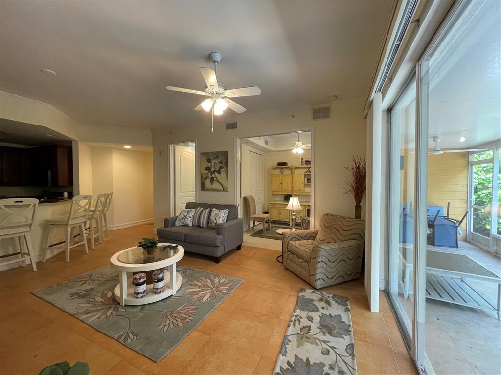 4400-4420 Bonita Beach Walk Drive, Unit MULTI Bonita Springs, FL 34134 - Photo 3 of 67 a living room with furniture a rug and a flat screen tv