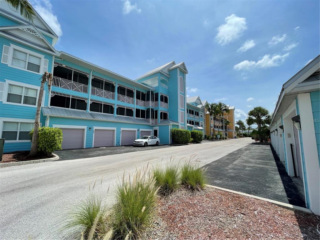4400-4420 Bonita Beach Walk Drive, Unit MULTI Bonita Springs, FL 34134 - Photo 31 of 67 a front view of a building with garden and parking