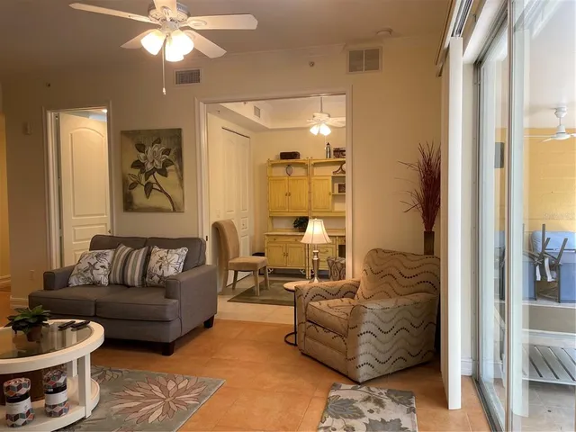 a room with furniture or chandelier and a large window