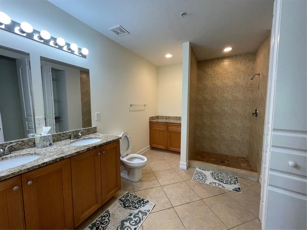4400-4420 Bonita Beach Walk Drive, Unit MULTI Bonita Springs, FL 34134 - Photo 44 of 67 a bathroom with a sink a toilet and shower
