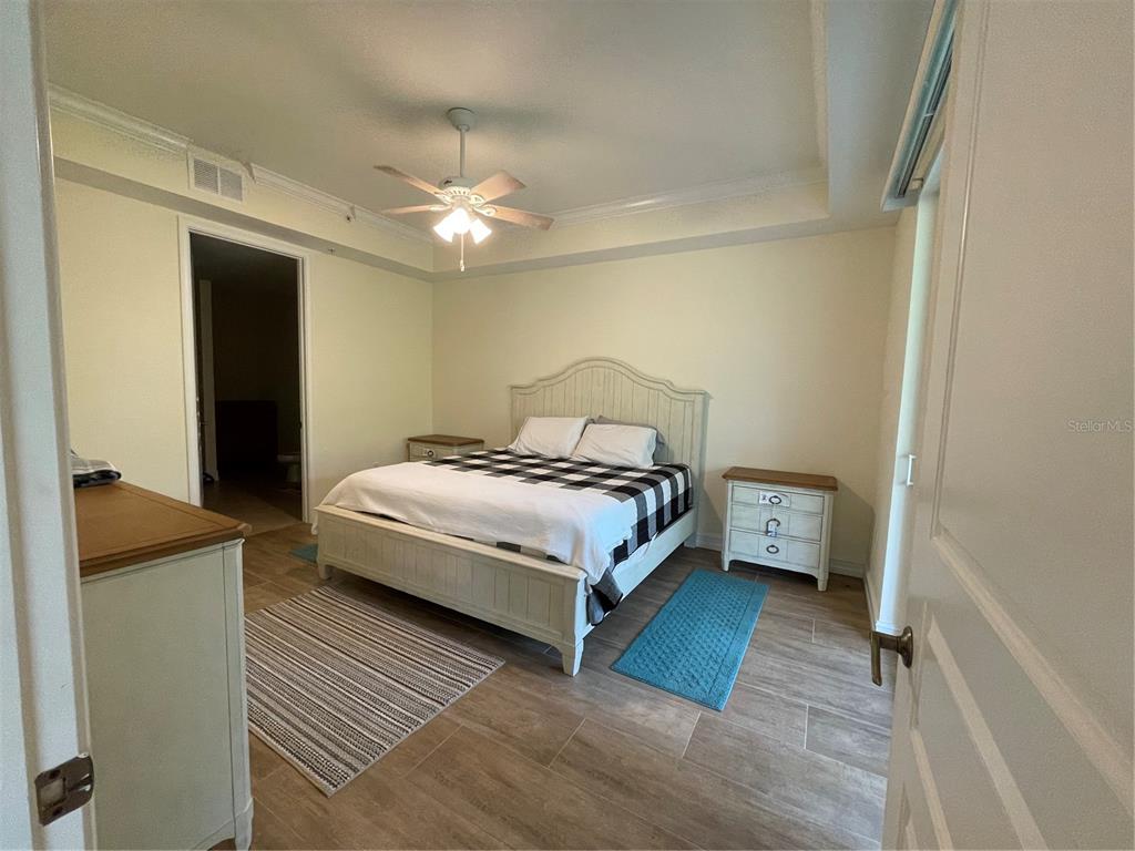 4400-4420 Bonita Beach Walk Drive, Unit MULTI Bonita Springs, FL 34134 - Photo 48 of 67 a bedroom with a bed and a ceiling fan