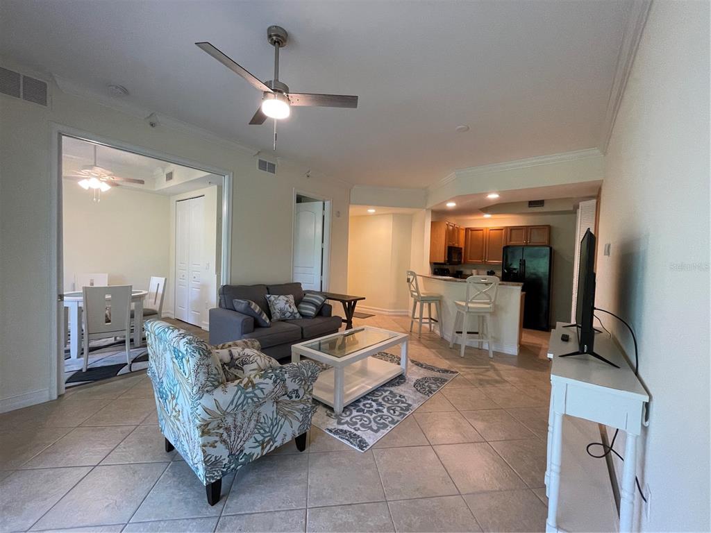 4400-4420 Bonita Beach Walk Drive, Unit MULTI Bonita Springs, FL 34134 - Photo 49 of 67 a living room with furniture a flat screen tv and a large mirror