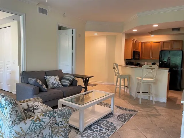 a living room with furniture a window and a rug