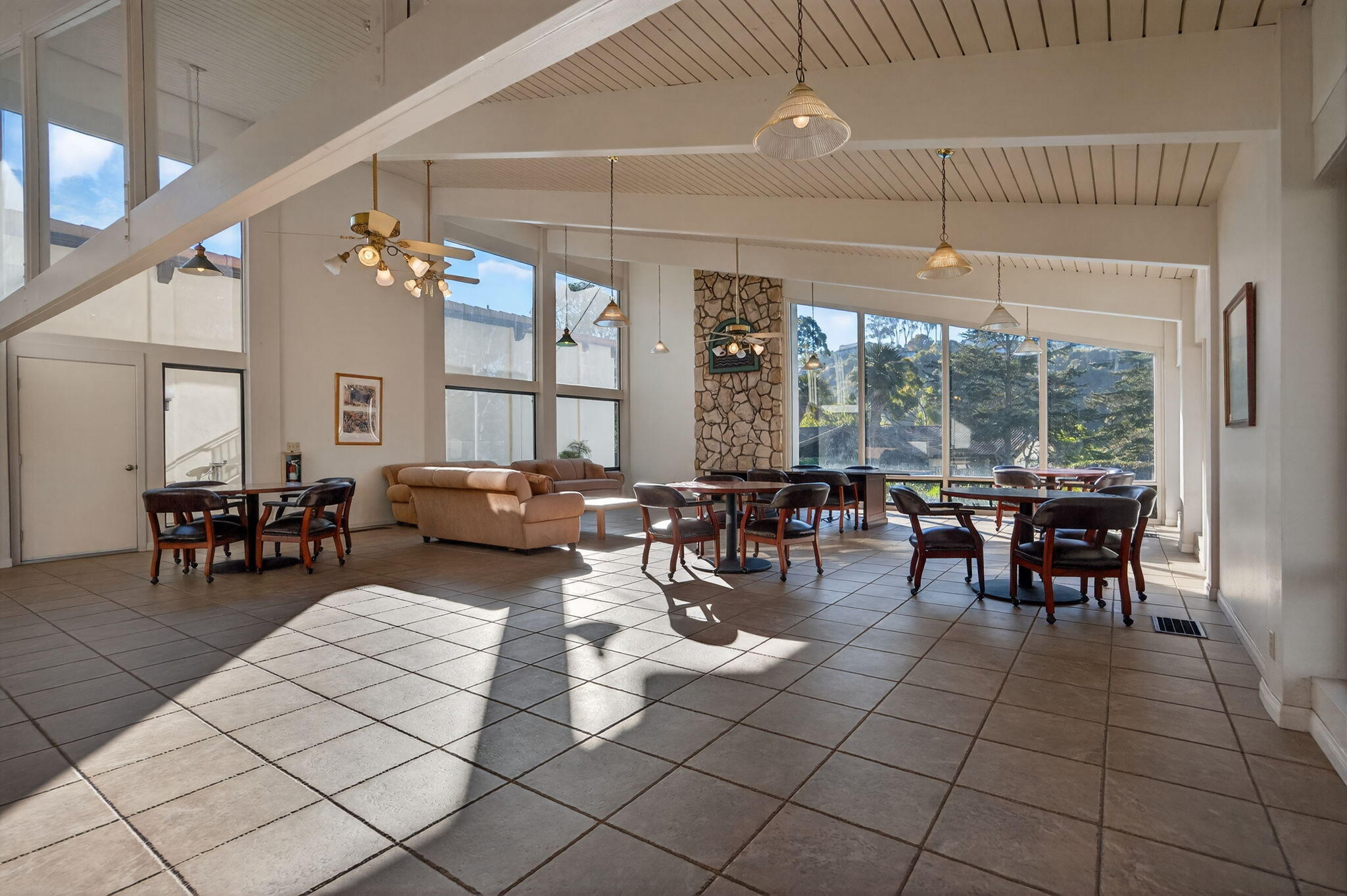 969 Miramonte Drive, Unit 5 Santa Barbara, CA 93109 - Photo 26 of 27 a living room with couches and a dining table with garden view