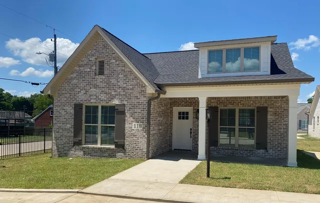 a front view of a house with a yard