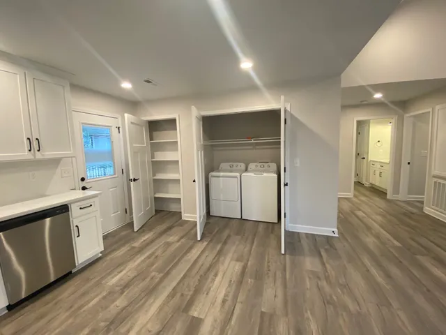 a kitchen with wooden floors and cabinets